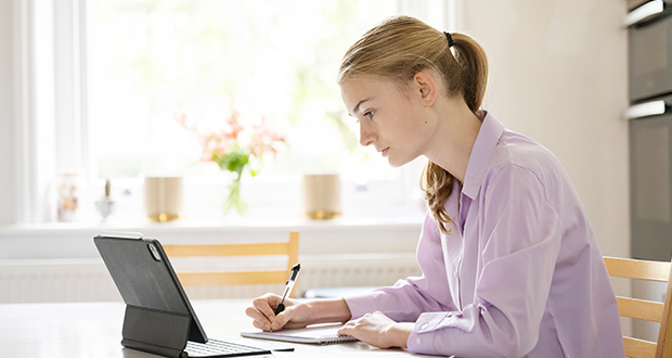 female student at home studying for exams