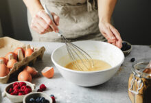 Picture shows a woman preparing cake batter. Cake mixes can teach us about AI, one speaker at EduTECH 2025 said.