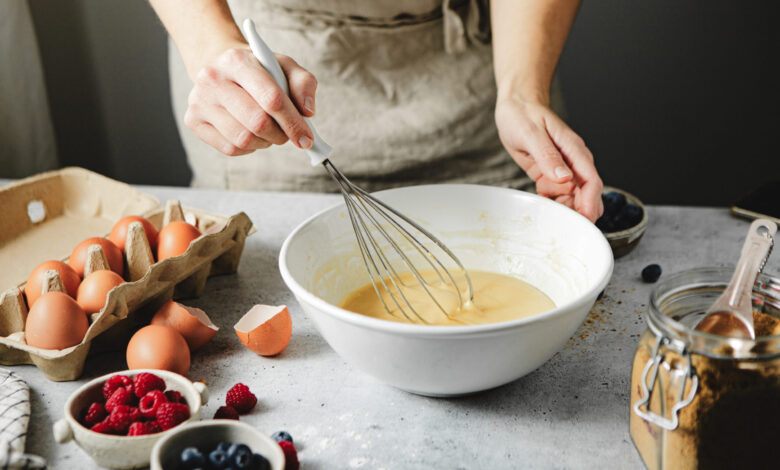 Picture shows a woman preparing cake batter. Cake mixes can teach us about AI, one speaker at EduTECH 2025 said.