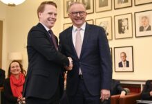 Prime Minister Anthony Albanese signs in Richard Dowling (left) at a Labor Caucus meeting. Picture: Martin Ollman