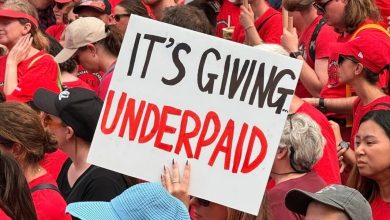 A Victorian teacher holds up a sign that says ‘It's giving underpaid’ at a strike on Thursday. Picture: Facebook.