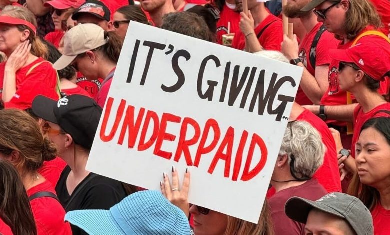 A Victorian teacher holds up a sign that says ‘It's giving underpaid’ at a strike on Thursday. Picture: Facebook.